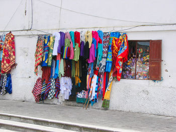 Clothes drying against wall at market