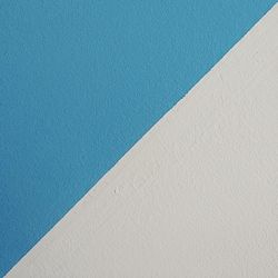 White wall against clear blue sky