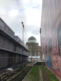 Railroad tracks in city against sky
