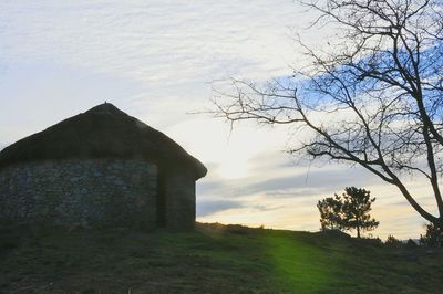 Built structure on landscape against sky