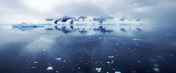 Scenic view of frozen lake against sky