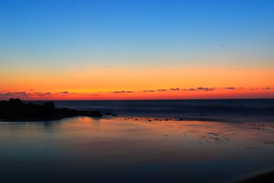 Scenic view of sea against clear sky during sunset