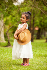 Cute girl standing on field