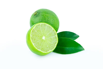 Close-up of green fruit against white background