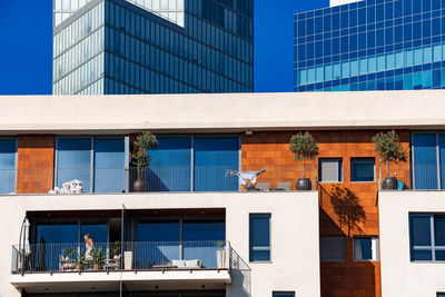 Low angle view of modern building against blue sky