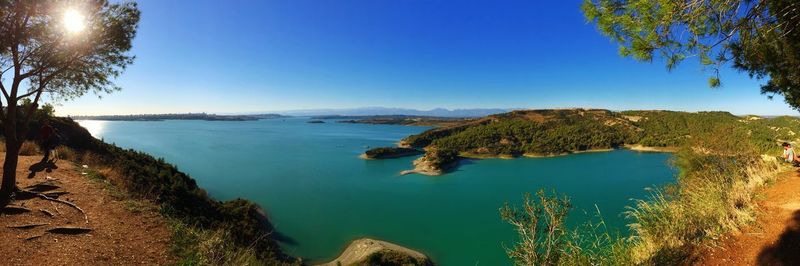 Panoramic view of sea against clear blue sky