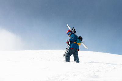 Man skiing on snow covered field