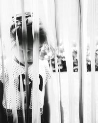 Close-up of girl standing in curtain