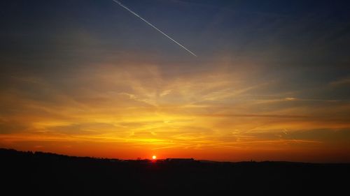 Silhouette landscape against sky during sunset