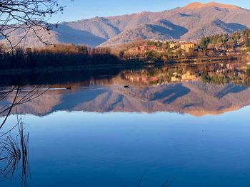 Scenic view of lake and mountains against sky