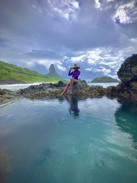 Rear view of woman standing in lake