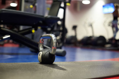 Weight stands on the floor in the gym against the background of sports equipment, close-up