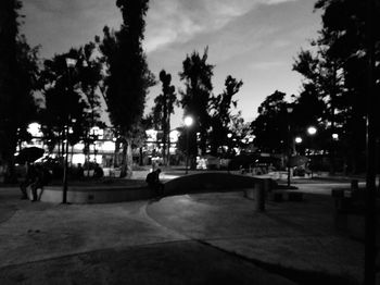 Silhouette people on street at night