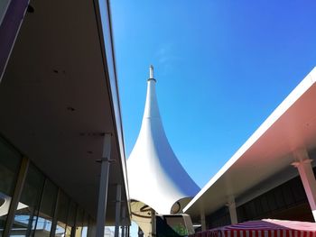 Low angle view of buildings against clear blue sky