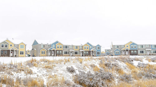 Residential buildings against sky during winter