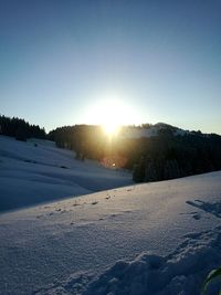 Frozen lake against sky during sunset