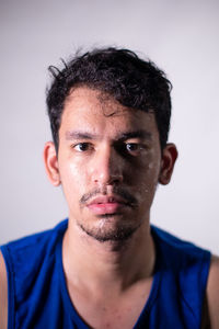 Close-up portrait of young man against white background