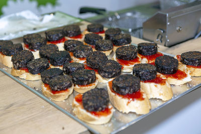 Tray of typical spanish tapas with blood sausage on a slice of bread called morcilla