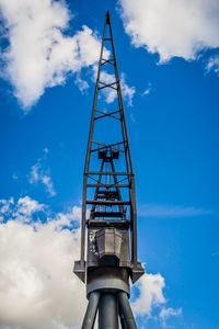 Low angle view of communications tower against blue sky