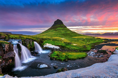 Scenic view of waterfall during sunset