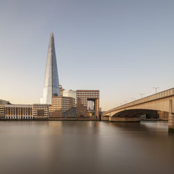 Bridge over river with buildings in background