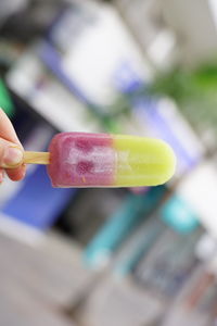 Close-up of hand holding ice cream