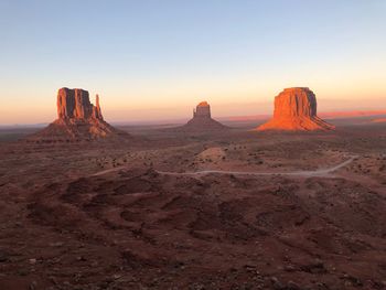 Scenic view of desert against sky during sunset