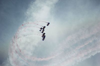 Low angle view of airshow against sky