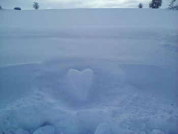 Close-up of heart shape in snow