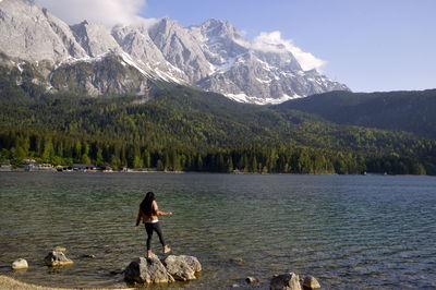 Man in lake against mountains