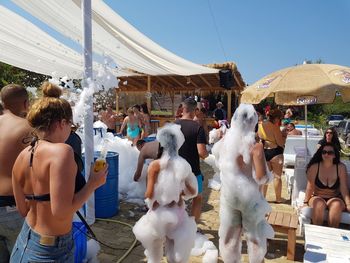 People with soap sud at beach