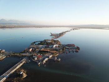 High angle view of city by sea against sky