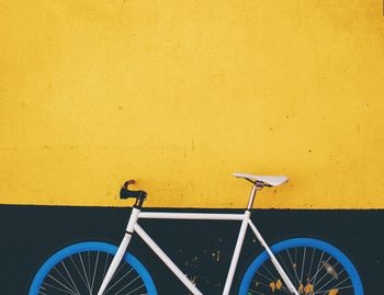 Close-up of bicycle against wall