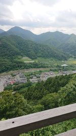 High angle view of green landscape against sky