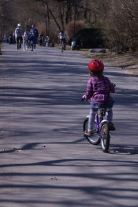 Woman riding bicycle on road