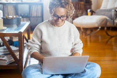 Midsection of woman using laptop