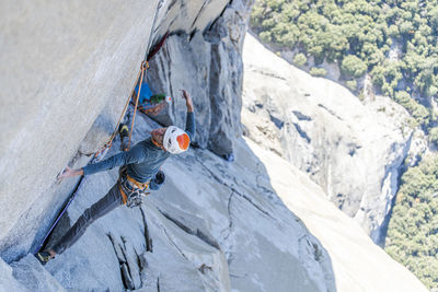 Rock climber crack climbing on the nose, el capitan in yosemite