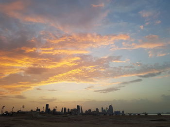 Silhouette buildings against sky during sunset