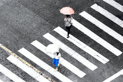 High angle view of people walking on road