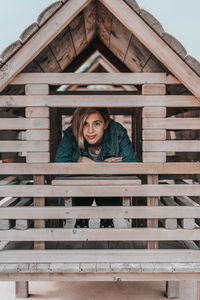 Portrait of smiling woman in wooden cabin