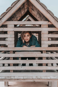 Portrait of woman standing against brick wall