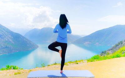 Full length of man standing on mountain against sky