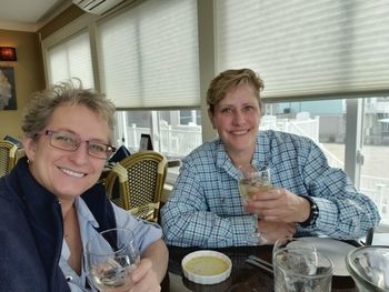 Portrait of a smiling young woman sitting at table