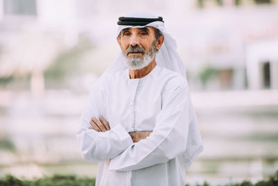 Portrait of senior man wearing dish dash with arms crossed