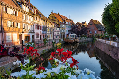 Scenic view of lake by buildings against sky