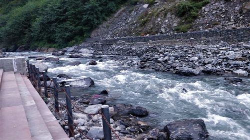 High angle view of river flowing through rocks