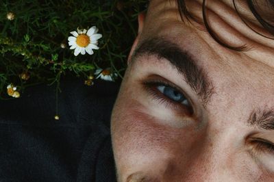 Close-up portrait of mature man with flower