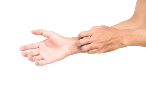 Close-up of hands over white background