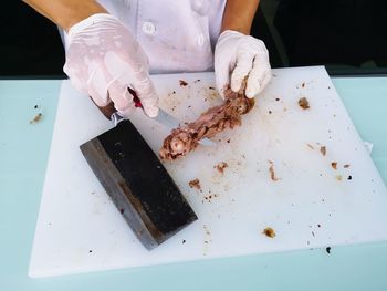 High angle view of person preparing food on table