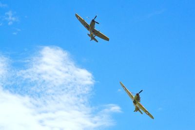 Low angle view of planes flying in sky